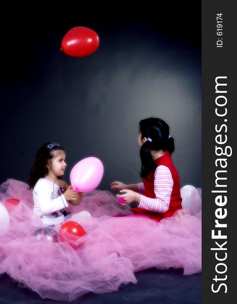 Young and beautiful girls playing with balloons