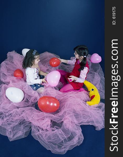 Young and beautiful girls playing with balloons