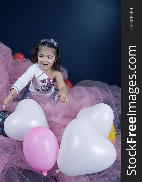 Pretty little girl chasing ballons. Pretty little girl chasing ballons