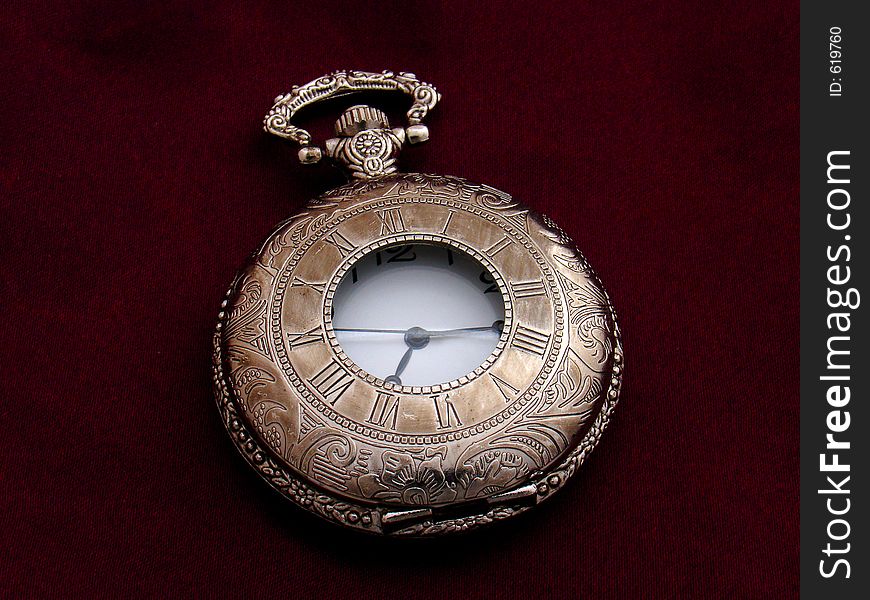 Old silver pocket watch on purple silk background