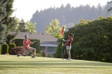 Couple Playing Golf - Horizontal Royalty Free Stock Photography