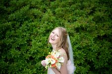 Laughing Bride Against Lush Foliage Royalty Free Stock Images