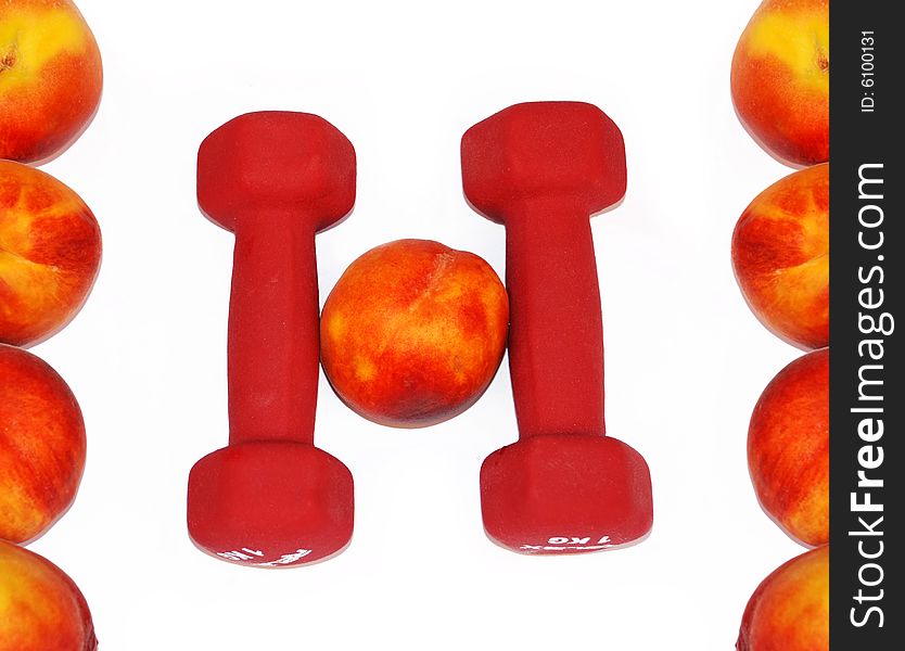 Appetizing fresh peaches and dumbbells in shape H letter. Appetizing fresh peaches and dumbbells in shape H letter