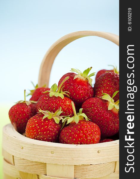 Close up of wooden basket full of strawberries