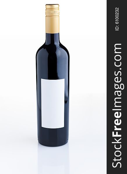 Red wine bottle with empty label over white background