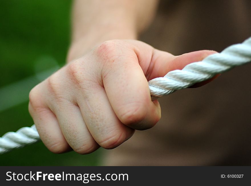 A close up with a rope and hand