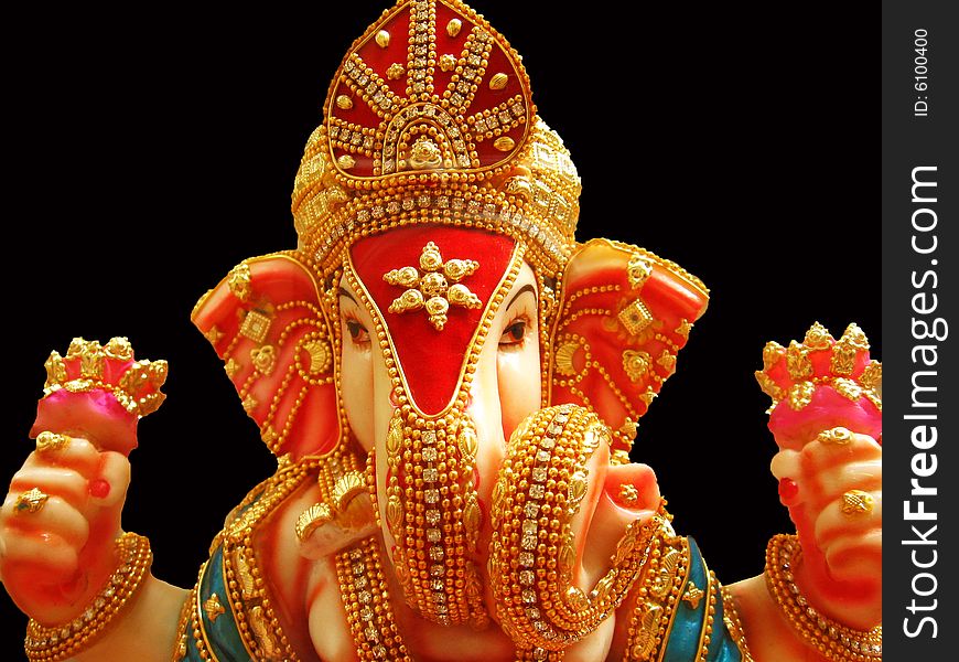 A beautiful idol of lord Ganesha with dazzling gold jewelery all over him. A beautiful idol of lord Ganesha with dazzling gold jewelery all over him