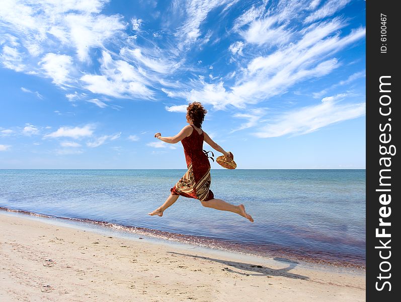 Girl running along sea coast