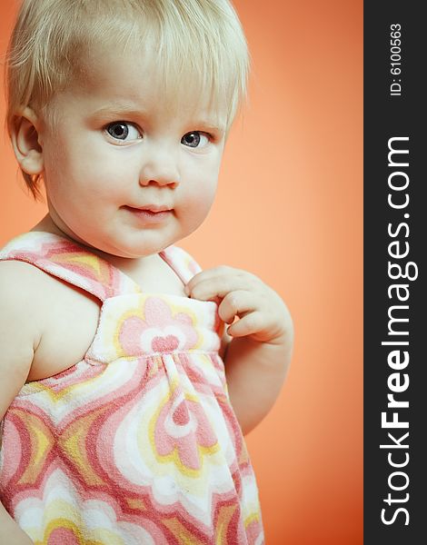 Portrait of small girl over orange background. Portrait of small girl over orange background