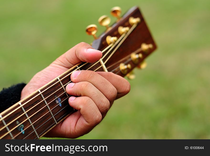 Hand of a guitarist playing a guitar