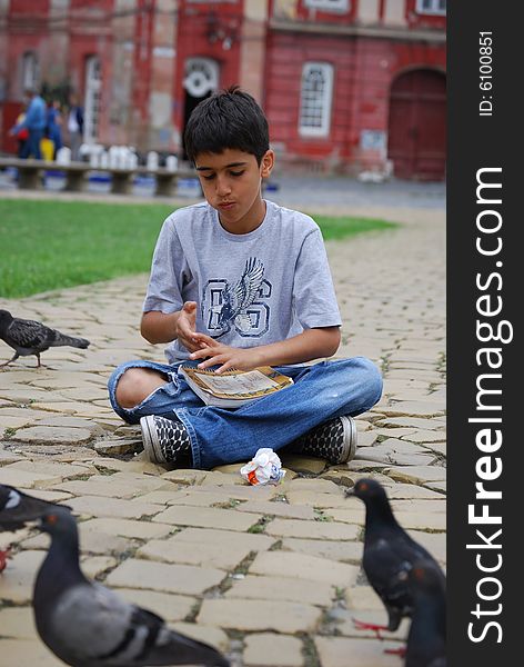 Having some fun, eating together with pigeons. Having some fun, eating together with pigeons