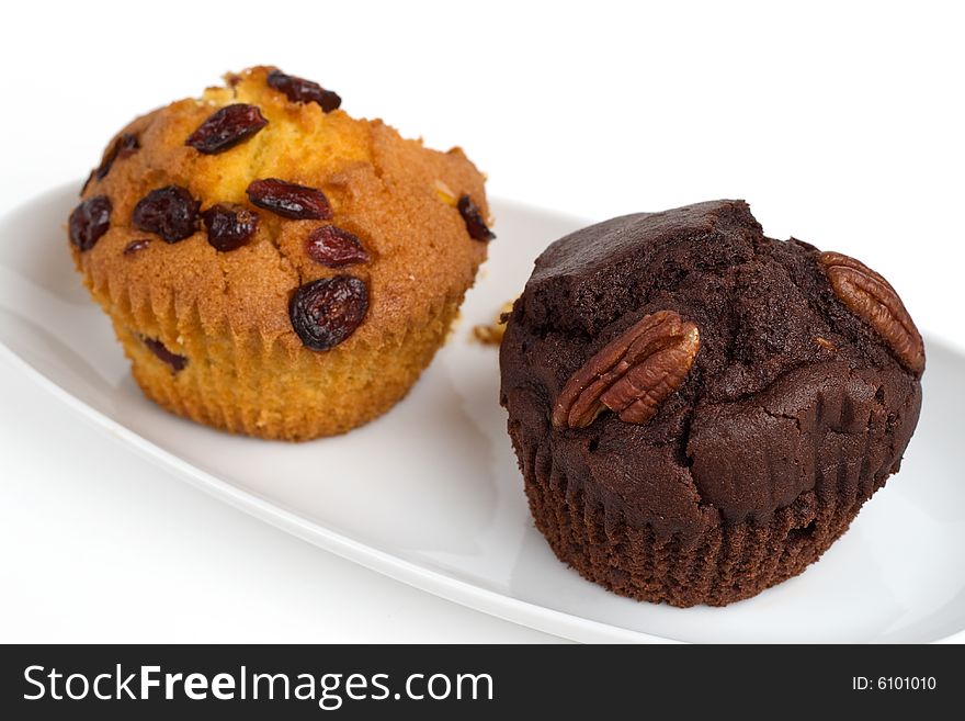 Two muffins on a plate, shallow DOF, isolated