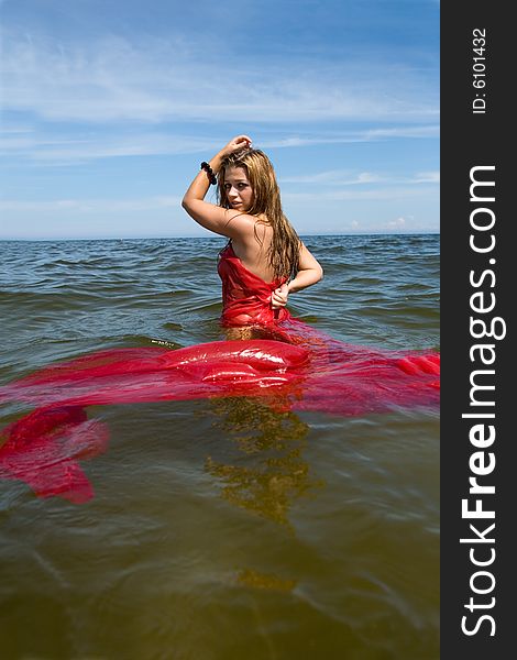 Beautiful Girl Swimming With Red Shawl