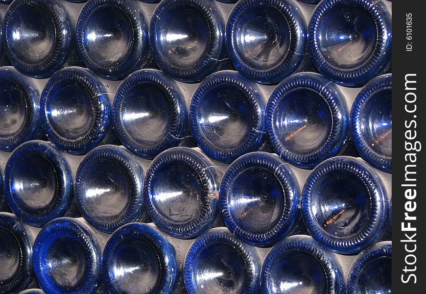 A stack of dusty blue wine bottles. A stack of dusty blue wine bottles