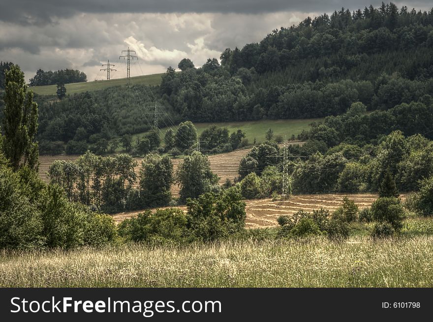 Late summer landscape from moravia with hill, trees, meadows, fields and electricity wires. Late summer landscape from moravia with hill, trees, meadows, fields and electricity wires