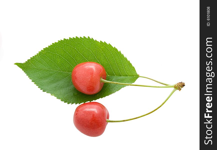 Cherry with a green leaf on white background.