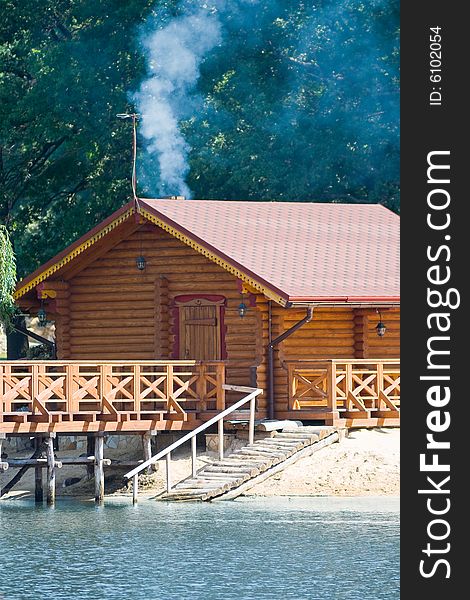 Wooden bath house on the river bank