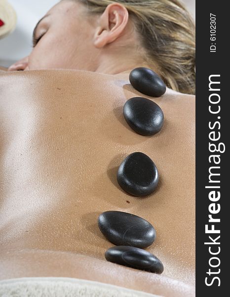 Woman having stone treatment on a spa. Woman having stone treatment on a spa