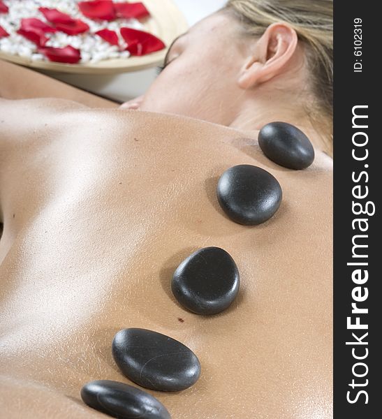 Woman having stone treatment on a spa. Woman having stone treatment on a spa