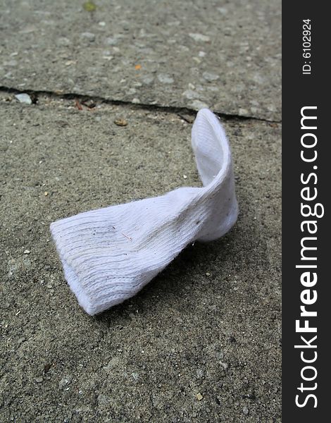 Photo of a child sock on the sidewalk. Photo of a child sock on the sidewalk