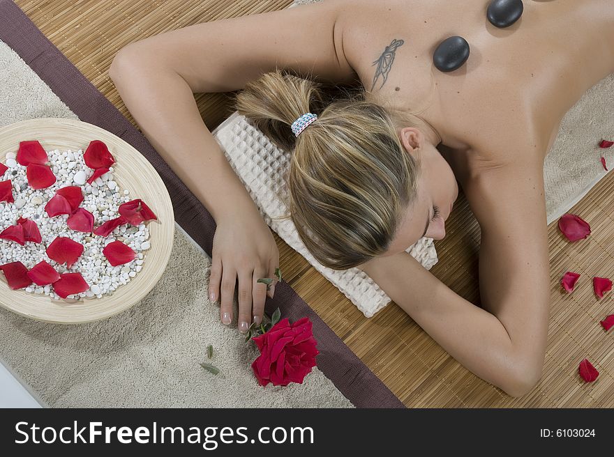 Woman having hot-stone massage
