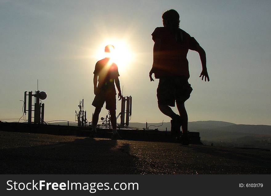 Silhouette on the roof. Sunset sky. Silhouette on the roof. Sunset sky