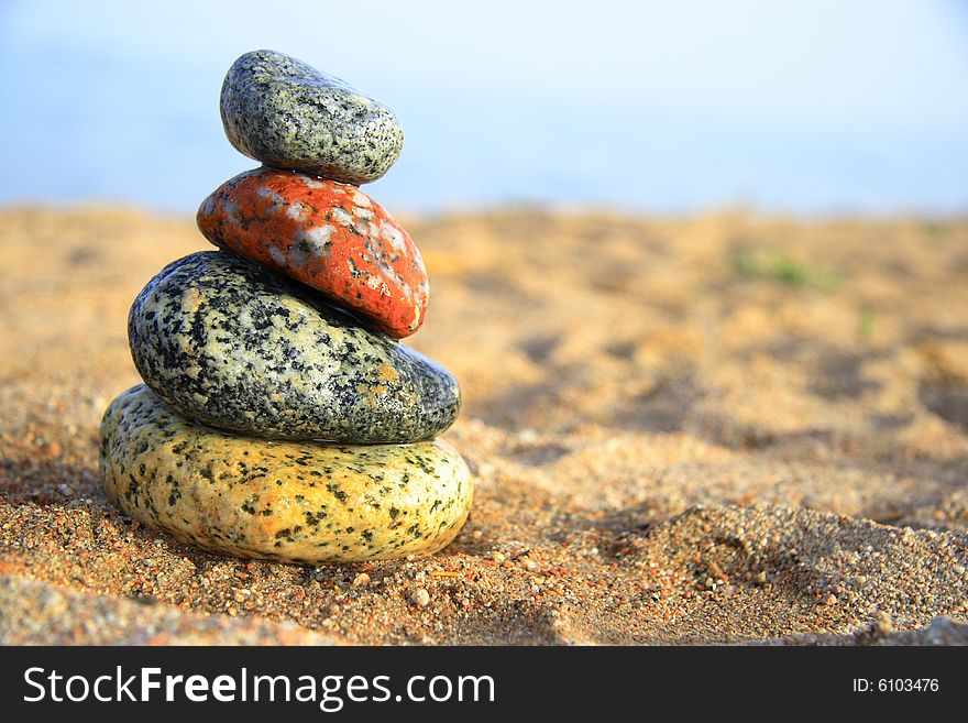 Stones on the seashore, blue sea