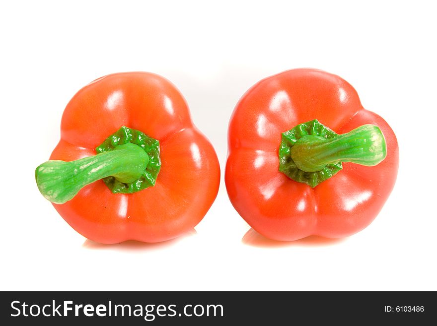 Two sweet peppers on white ground