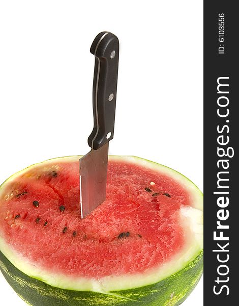 Half of juicy watermelon with knife on white ground