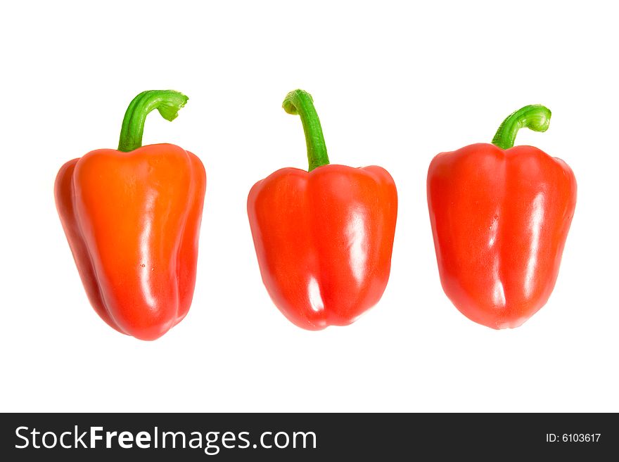 Three red sweet peppers on white ground. Three red sweet peppers on white ground