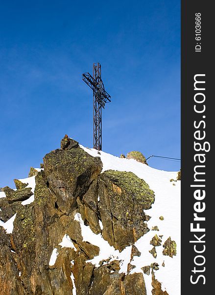 Cross on top of the peak.