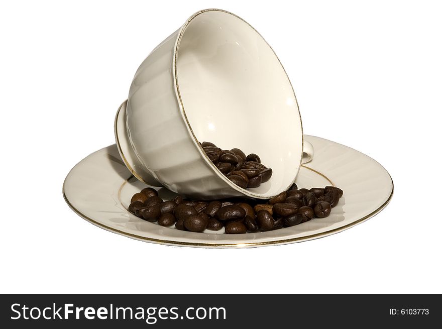 Coffee cup lying on a side filled with coffee beans isolated on white. Coffee cup lying on a side filled with coffee beans isolated on white
