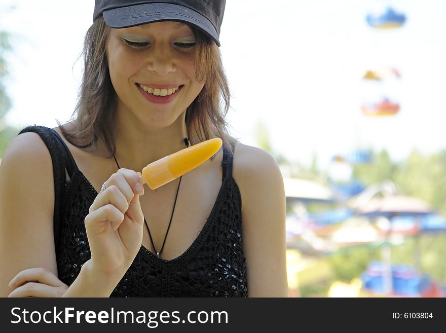 The girl with fruit ice in park. The girl with fruit ice in park