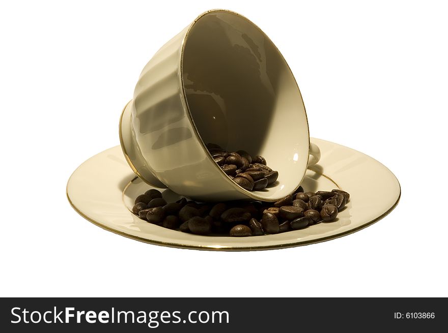 Coffee cup lying on a side filled with coffee beans in sepia tones isolated on white. Coffee cup lying on a side filled with coffee beans in sepia tones isolated on white