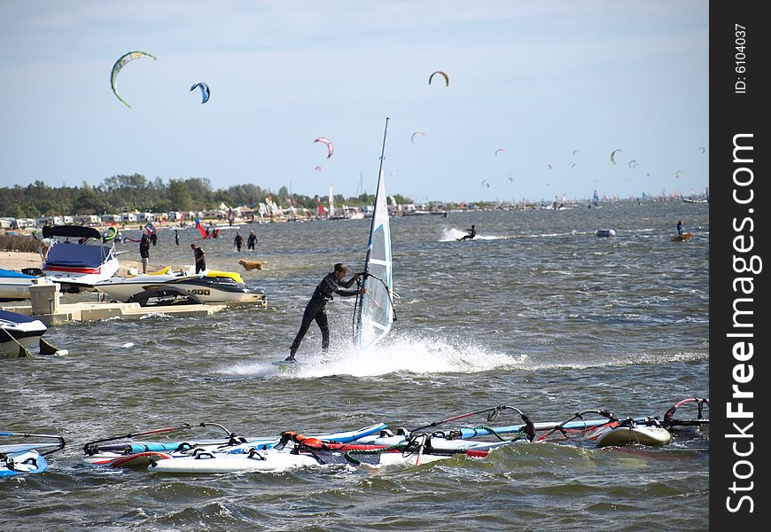 Men on windsurfing, sun, blue sky and sea