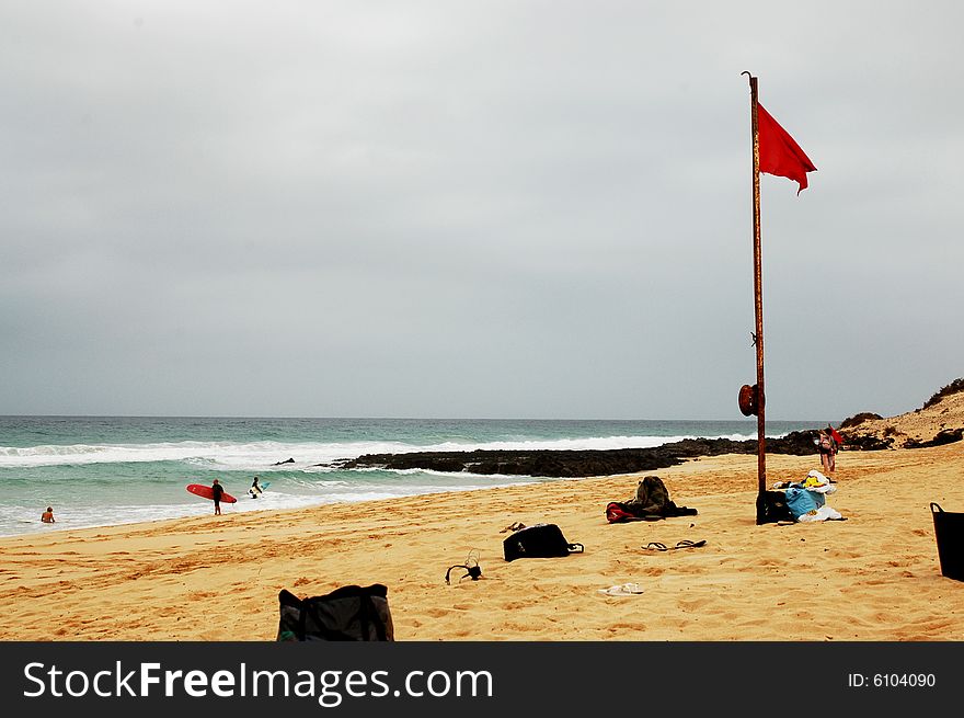 Red flag on the beach indicating baths forbidden