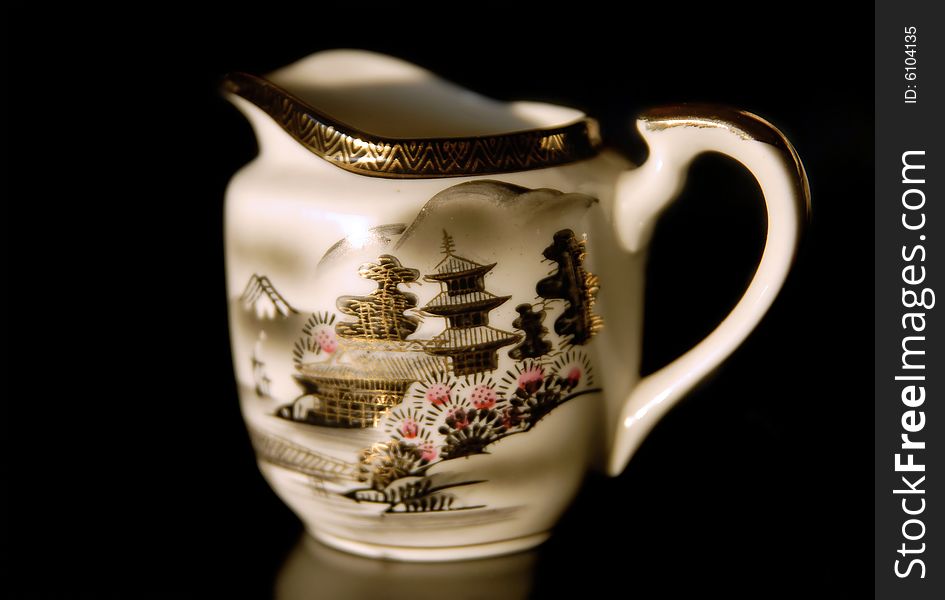 Jug with designs isolated on black