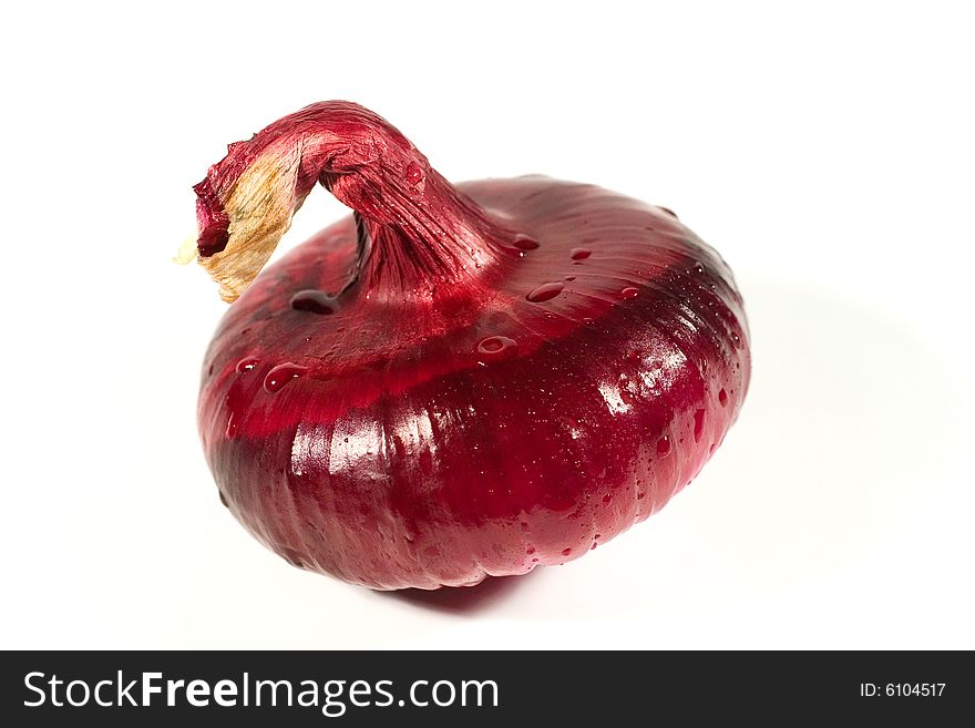 Closeup of a red onion with drops of water (on white)