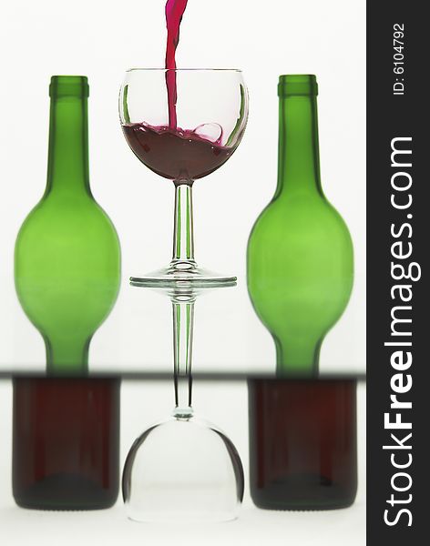 Wine pouring into a glass against semi abstract background
