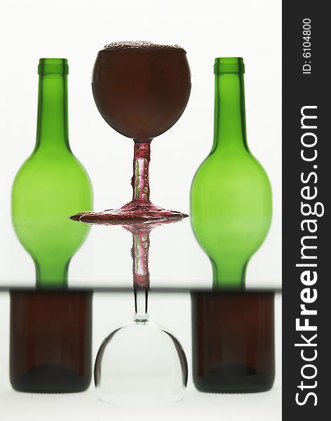 Wine in a glass overflowing against semi abstract background. Wine in a glass overflowing against semi abstract background