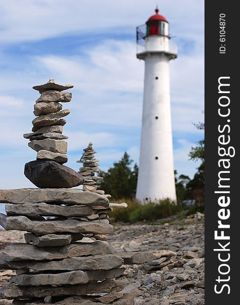 Lighthouse on the coastline and stones. Lighthouse on the coastline and stones