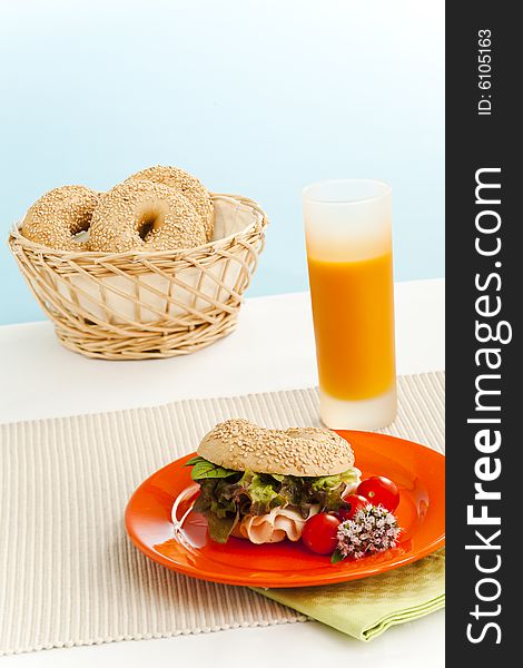 Breakfast bagels on the kitchen table over blue background