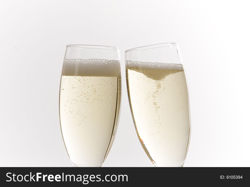 Champagne glasses on white ground