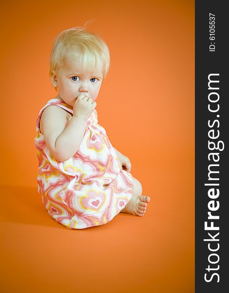 Small baby girl sitting on the floor. Small baby girl sitting on the floor