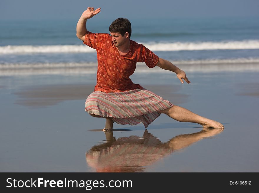 Man Is Doing East Gymnastic On The Beach