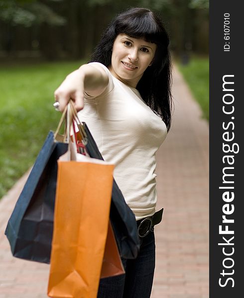 Attractive yound girl with shopping bags in her hand