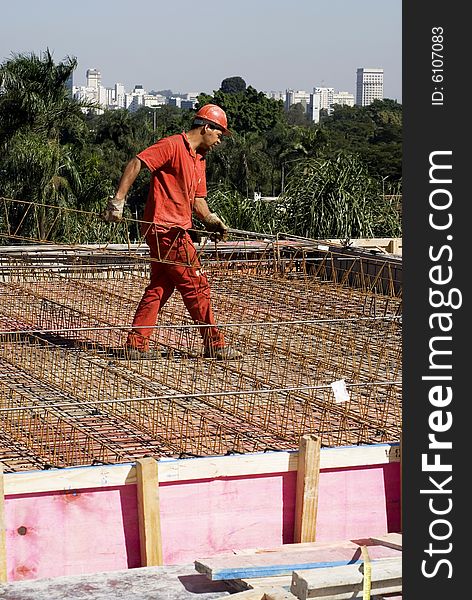 Construction Worker Holds Rebar - Vertical