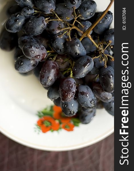 Shooting of a cluster of vine is in a dish, natural light. Shooting of a cluster of vine is in a dish, natural light.