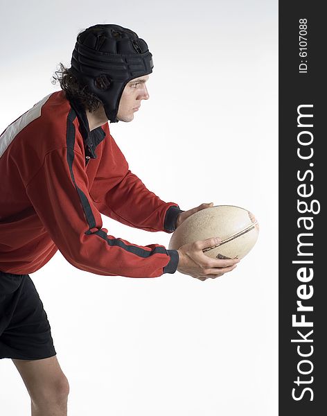 Man wearing a rugby uniform holds a football - Vertically framed photograph. Man wearing a rugby uniform holds a football - Vertically framed photograph