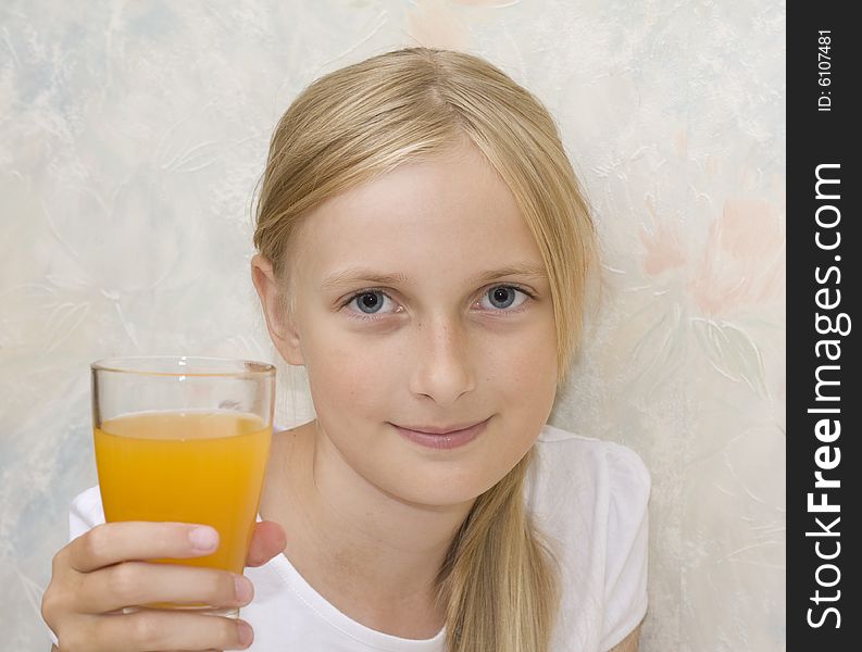 Young teenager girl drinking orange juice